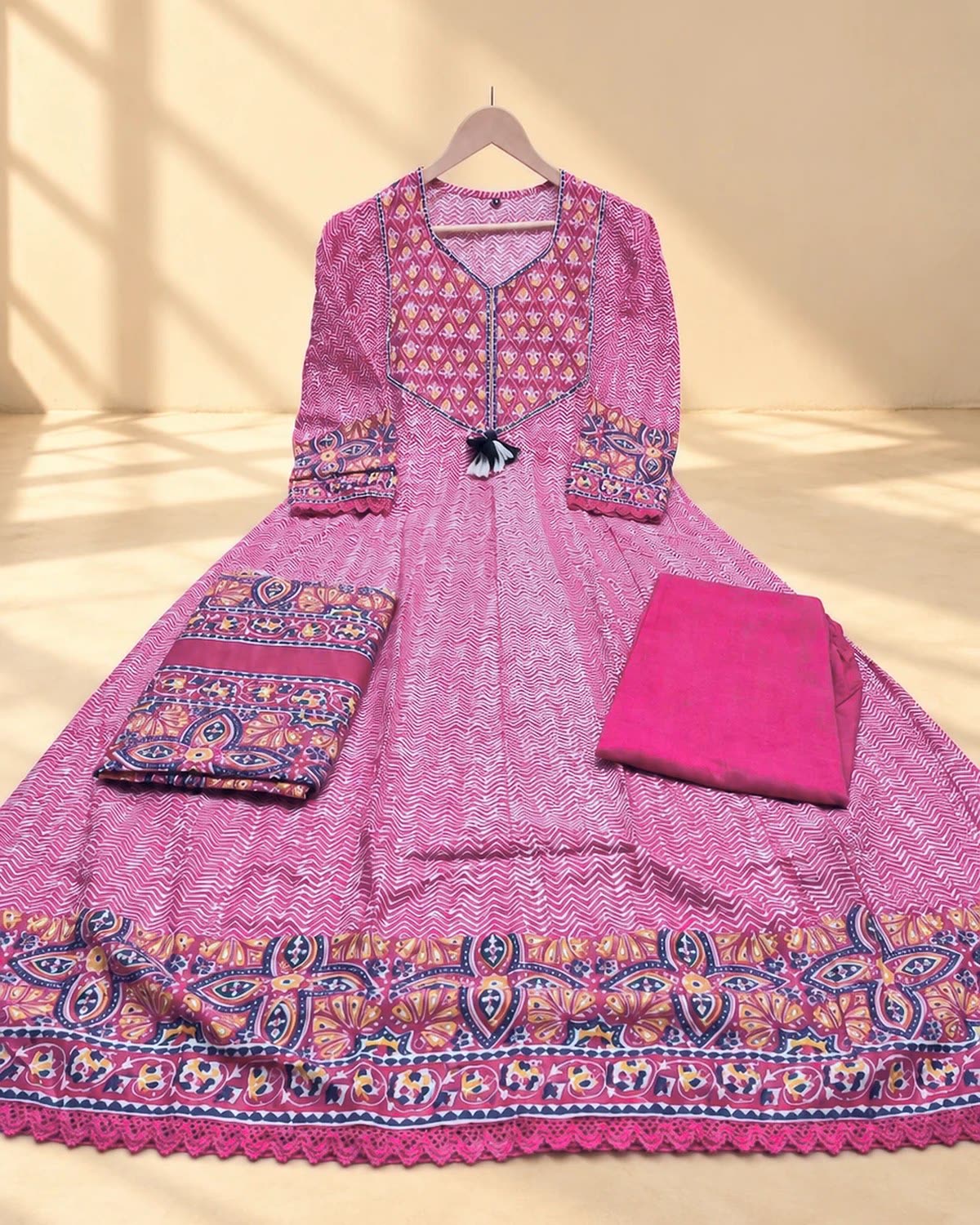 Pink printed cotton anarkali kurti with matching pant and dupatta, laid flat